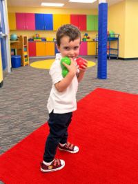 Preschool student playing with balls in the motor skills room